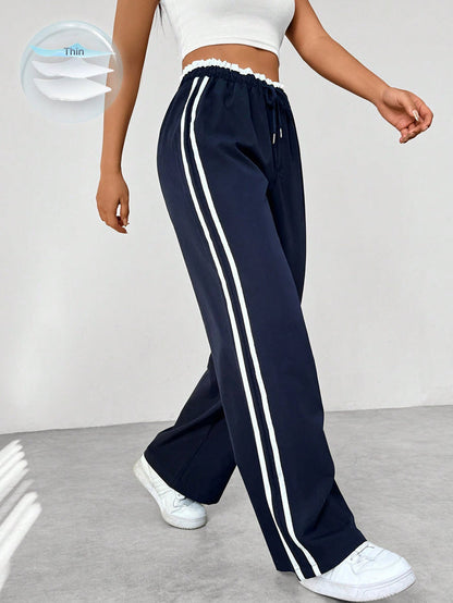 Katia | Loose-fit high-waisted track pants with side stripes